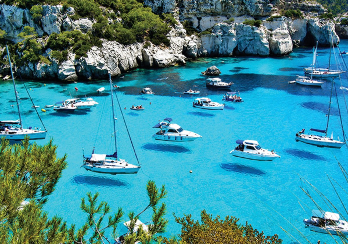 Boats moored in a sheltered coastal bay